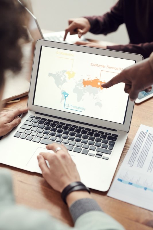 Laptop showing a world map of regional targets during a working session