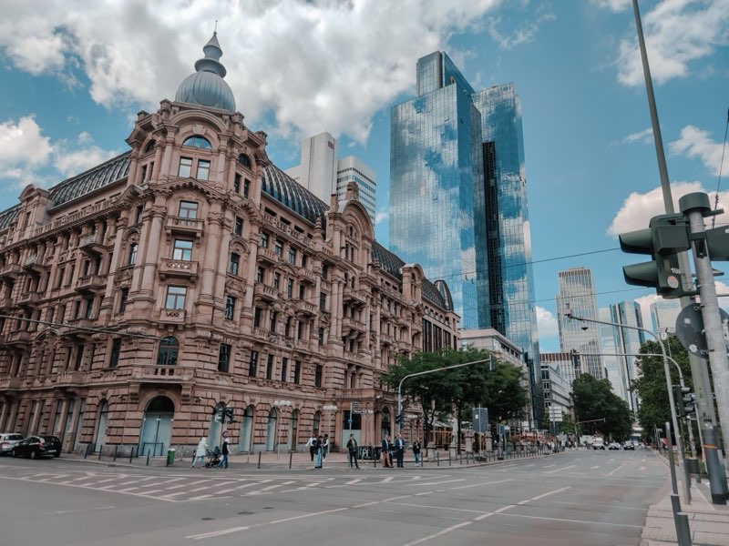 Historic and modern office buildings at a city crossroads