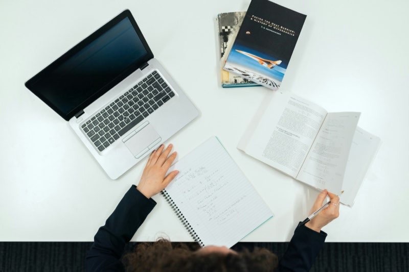 Laptop and notes on a desk during a working session